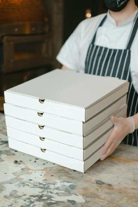 White cardboard pizza boxes ready for delivery